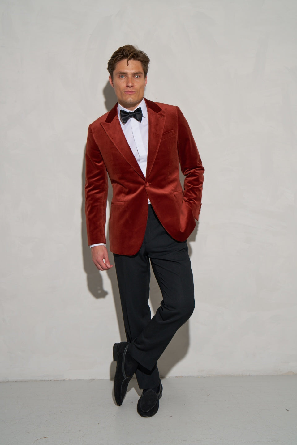 Rust velvet dinner jacket with a black bow tie