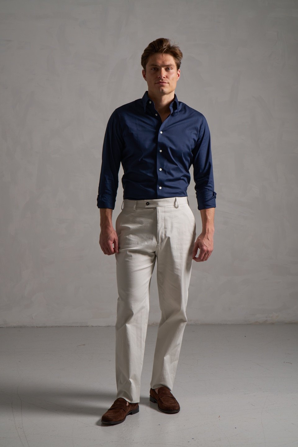 navy blue dress shirt and cream trousers