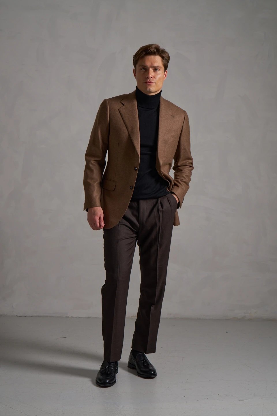 brown blazer with black turtleneck and trousers