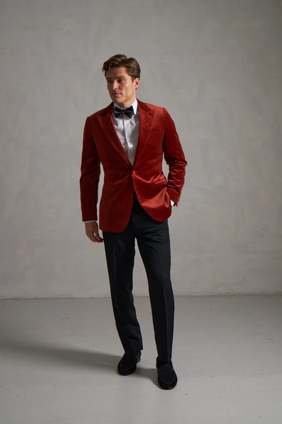 Rust velvet dinner jacket worn with black trousers and suede loafers