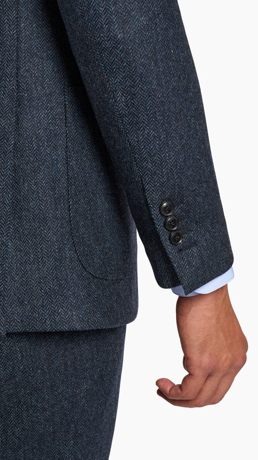 Close-up of sleeve and pocket detail on Abraham Moon Navy Tweed Suit made of textured 100% wool fabric.