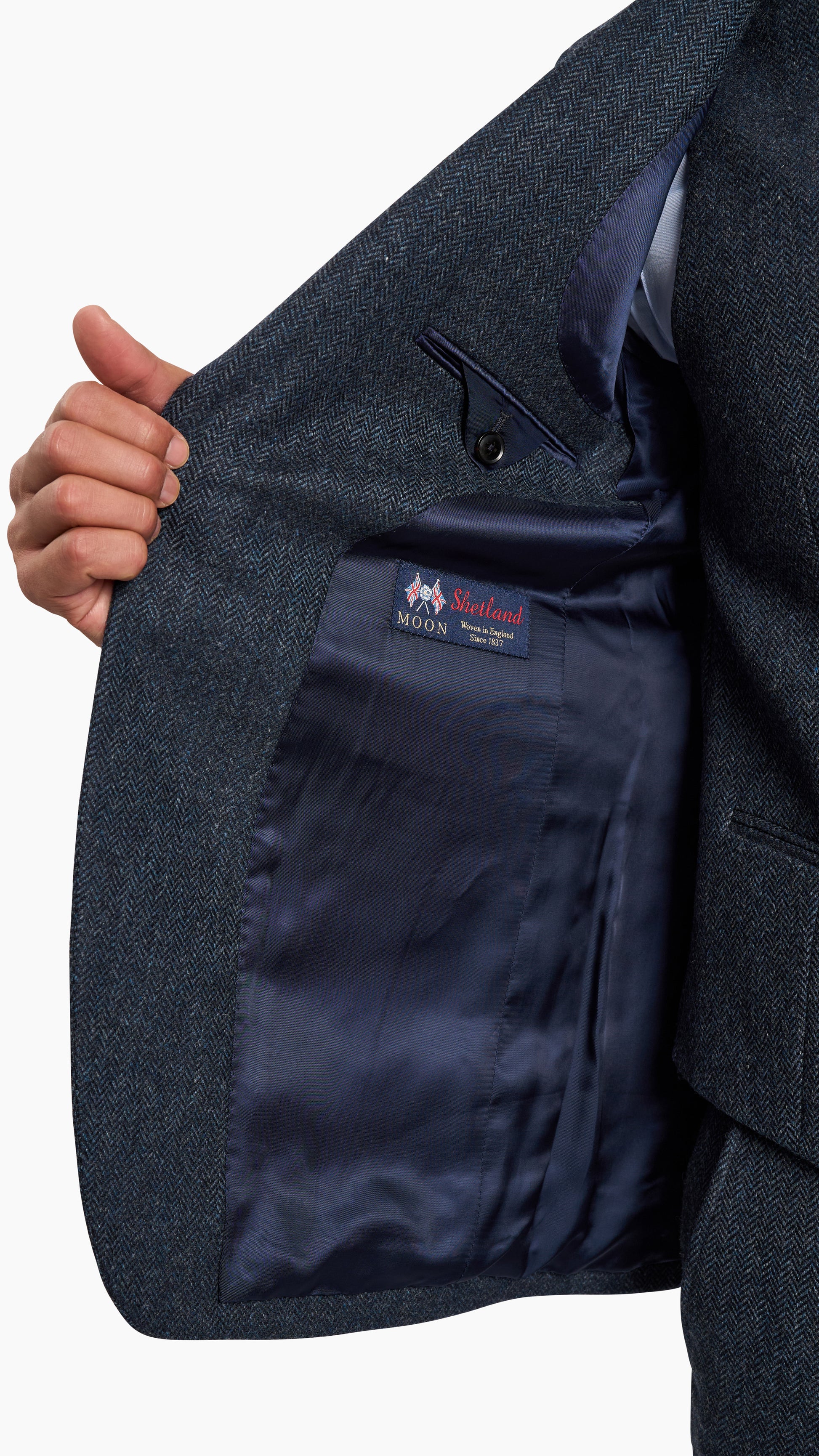 Abraham Moon Navy Tweed Suit showing detailed navy blue tweed fabric and smooth satin inner lining with label.