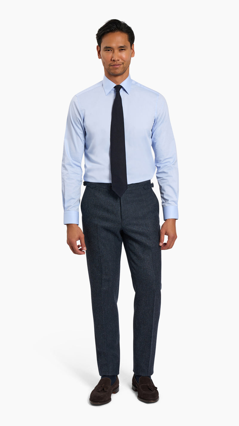 Abraham Moon Navy Tweed Suit with tailored wool trousers worn with light blue shirt and black tie.