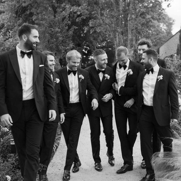 Groomsmen wearing tailored black tuxedos Edit Suits Co.