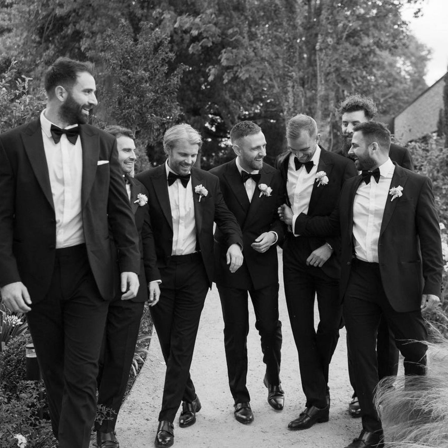Groomsmen wearing tailored black tuxedos Edit Suits Co.