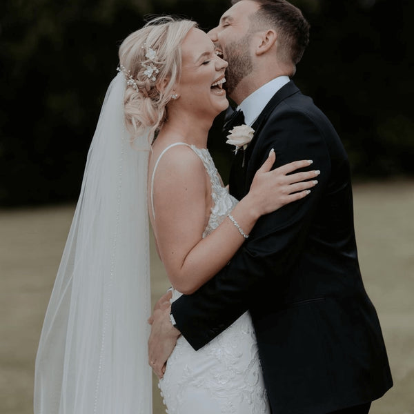 Groom wearing a tailored black tie tuxedo