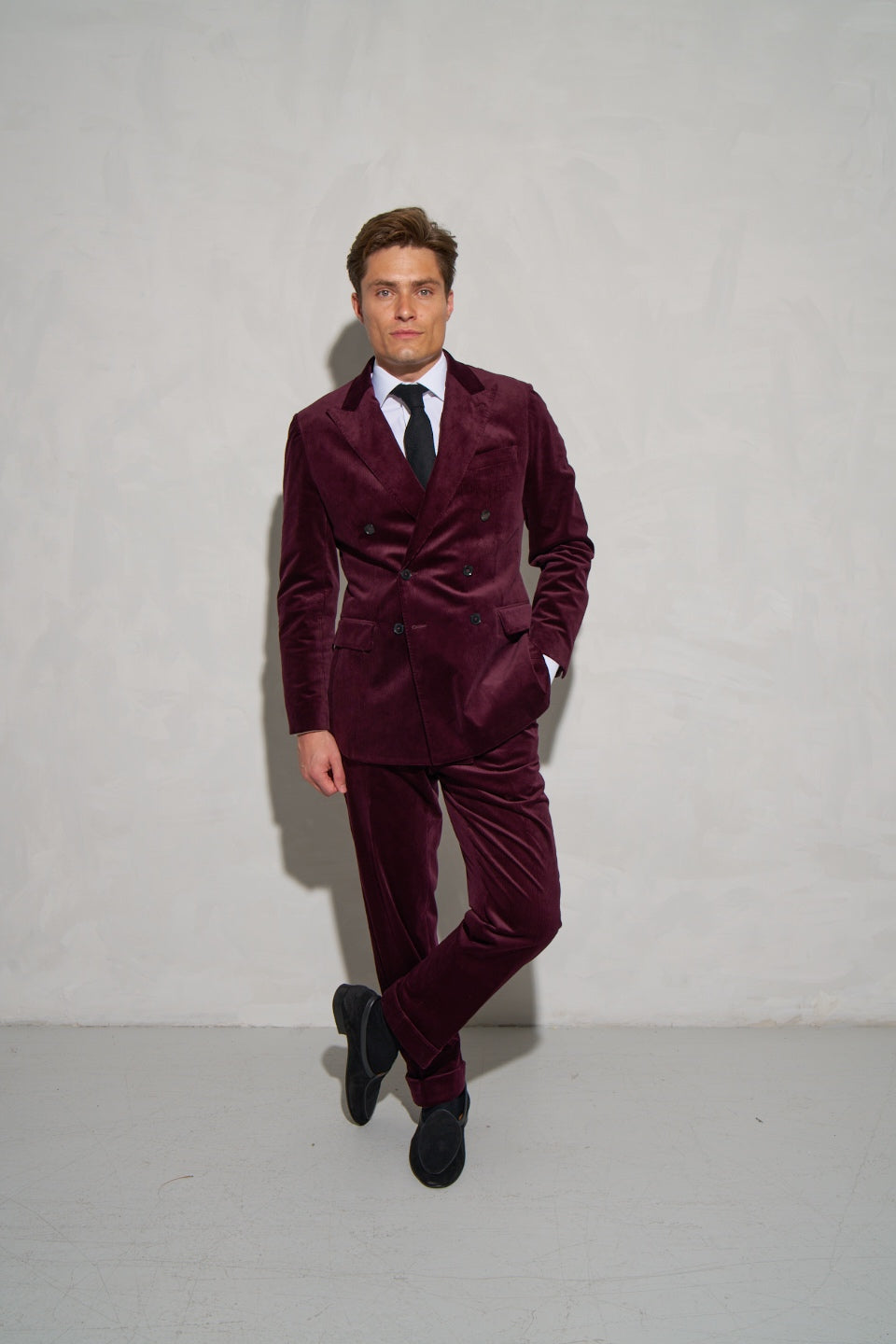 Burgundy corduroy double-breasted suit with a white shirt and tie