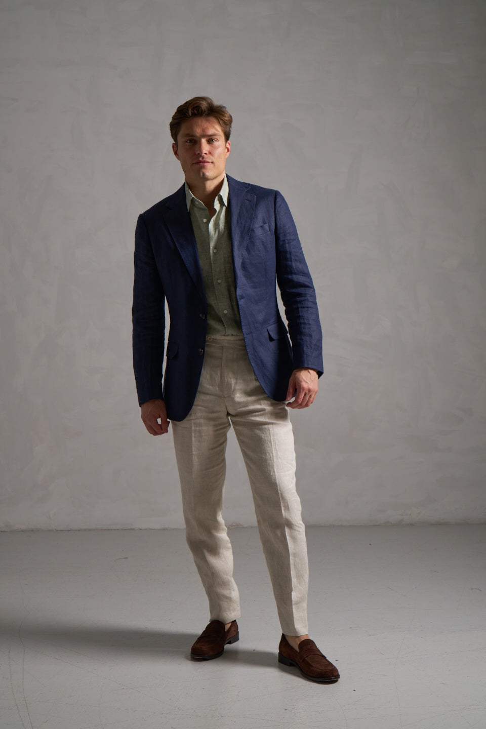 Navy linen jacket with a green linen shirt and cream trousers