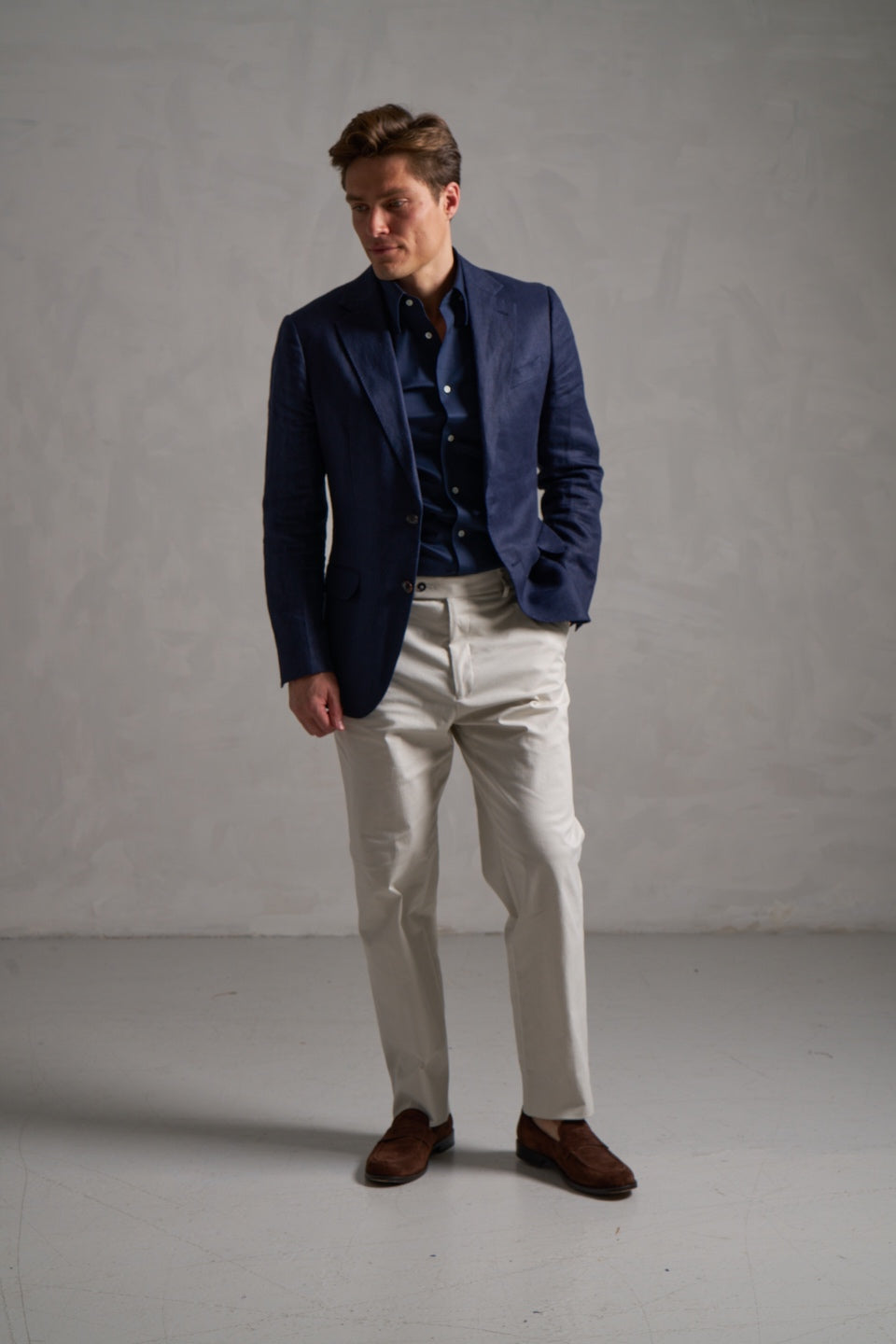 Navy linen jacket with a navy shirt and cream trousers