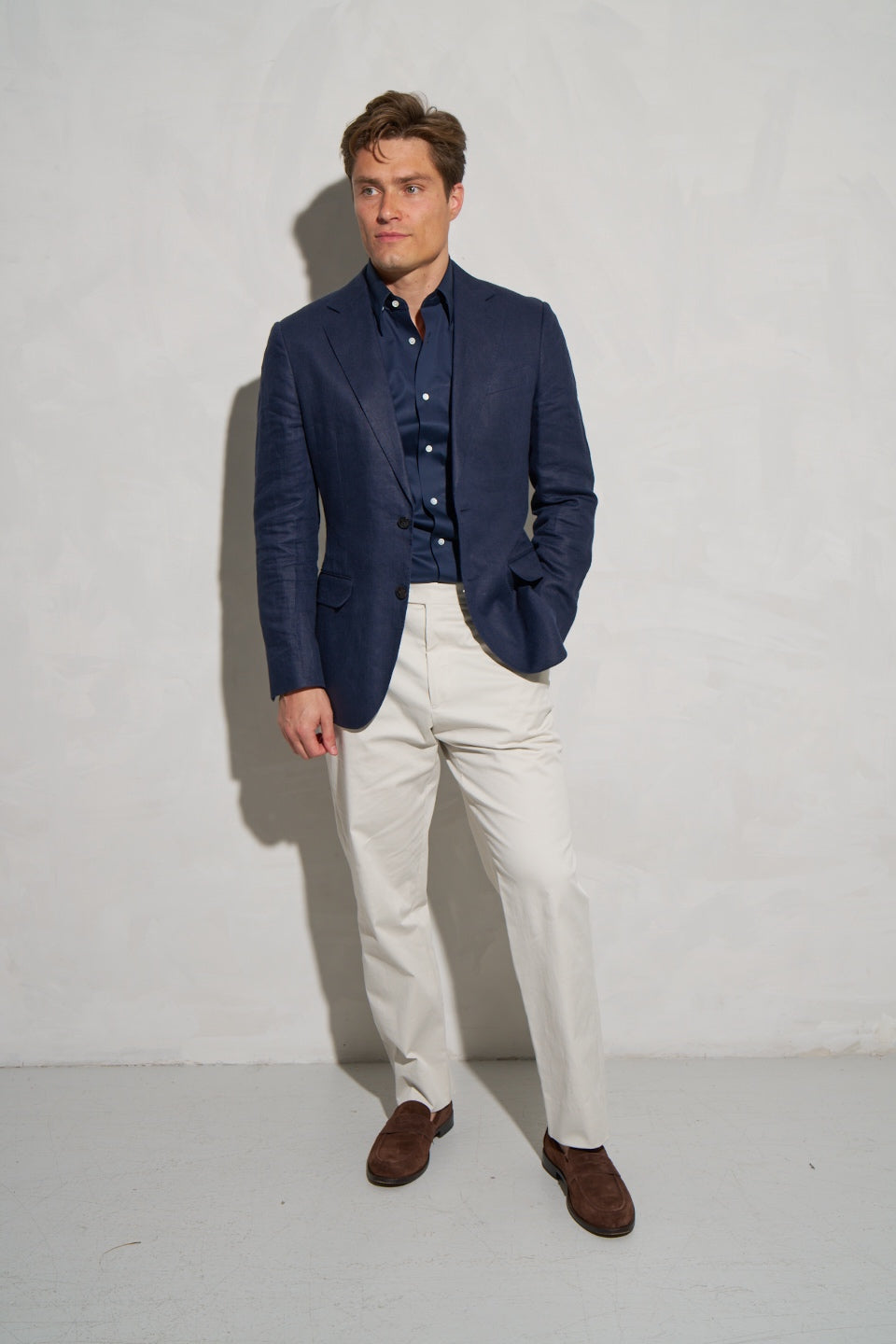 Navy linen jacket with cream linen trousers, full length