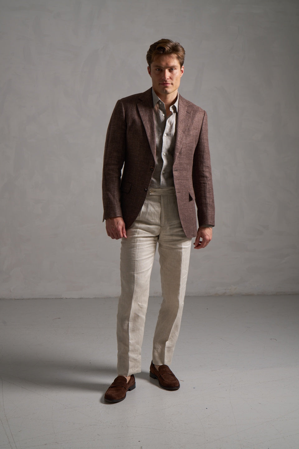 Brown linen blazer with grey linen shirt and cream trousers