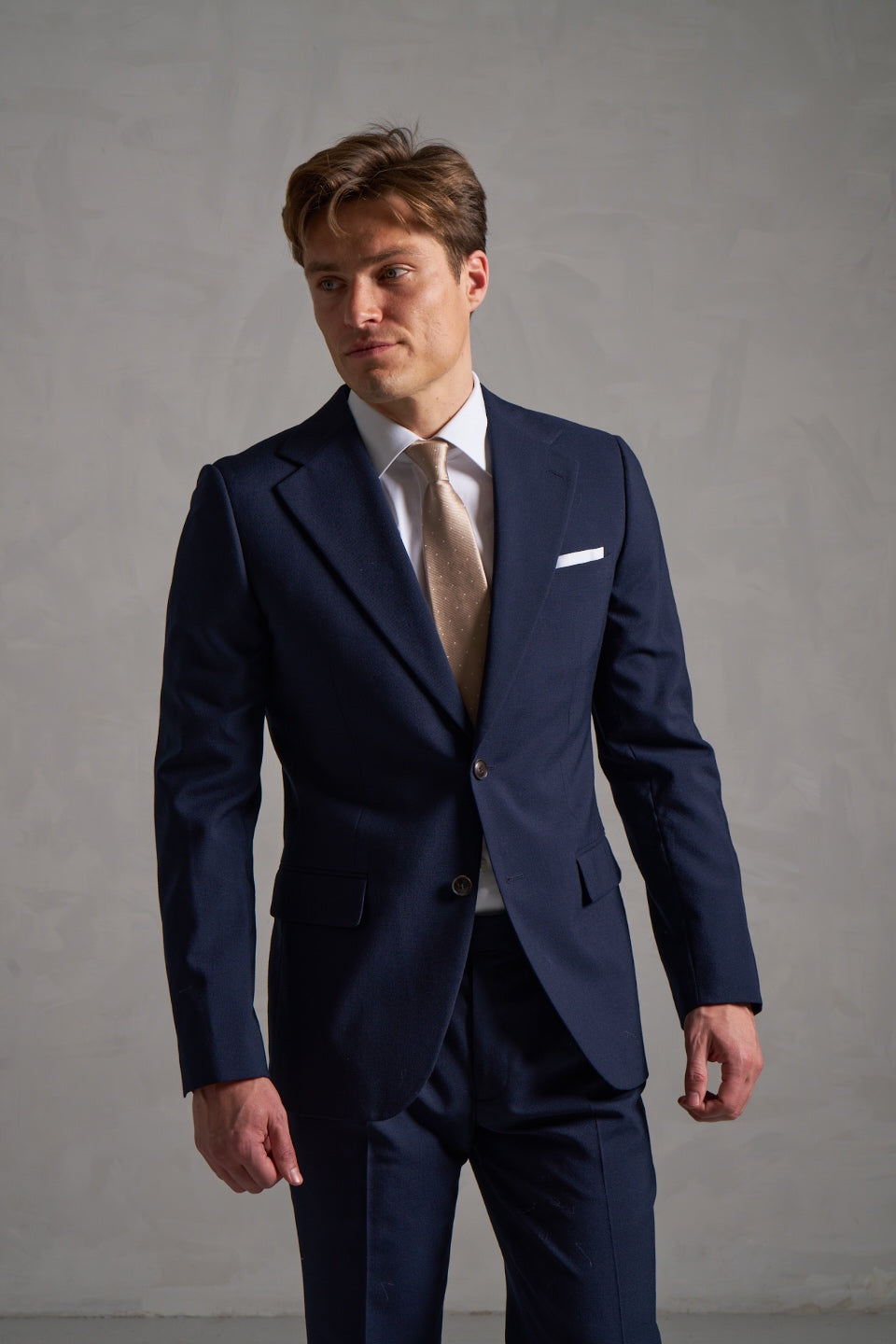 Navy made-to-measure suit with a gold tie